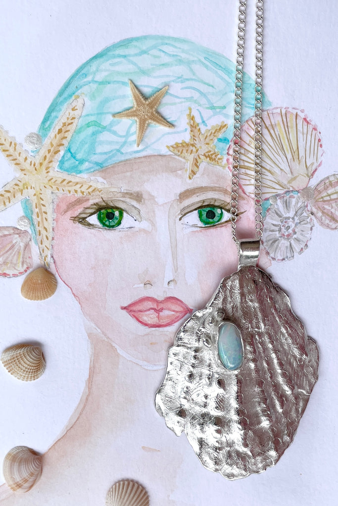 The pendant is solid silver, it is cast from an old sea worn shell and has a beautiful Australian opal set onto the front. This pendant is totally unique, it has the feeling of the spirit of the ocean