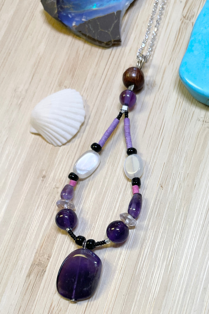 Handmade talisman pendant, featuring a mix of natural material