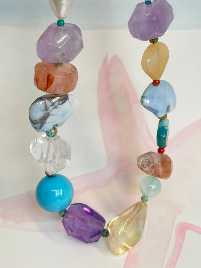 The necklace features two hand carved Zuni bears bought in Tucson Arizona. Stones are Natural Turquoise, Pearl, Amethyst, Carnelian, Clear Rock Crystal Blue Lace Agate,. Citrine, Mother of Pearl shell, Strawberry Quartz and Peridot. 