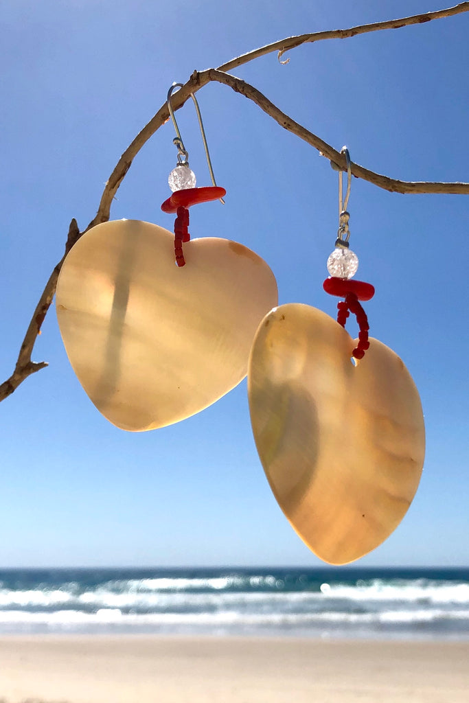 The polished Mother of Pearl shell has been hand cut into a heart shape then polished. The detal is of Red Bamboo coral, crackle rock crystal and handmade sand beads, the hook is silver.