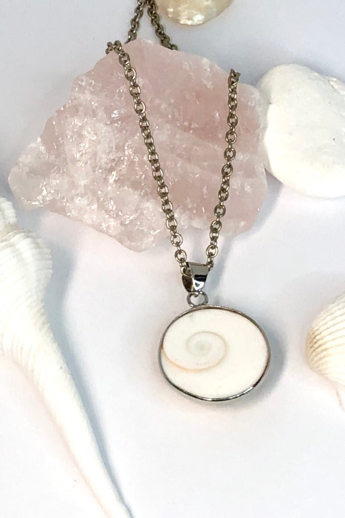 This pendant is known as Shiva Shell, and sometimes called Pacific Cat’s Eye. 