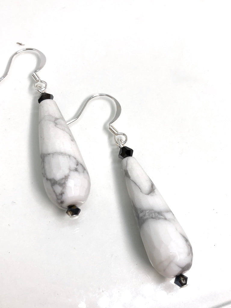 Earrings Rock Droplet White Marbled features approximately 6cm length, drop style earrings. 925 silver hook earrings and black teardrop shaped stone with a swarovski crystal bead on top.