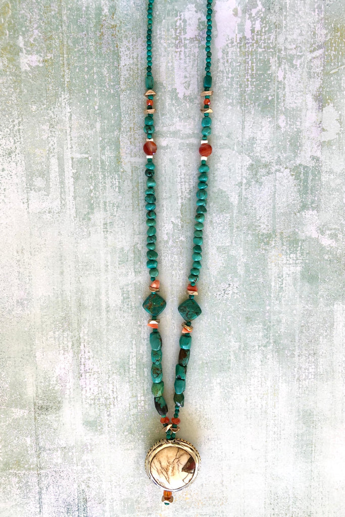 The centre piece is an inlaid Naga conch shell bead from Tibet. The beads are all genuine natural Turquoise, very irregular and some are very old.