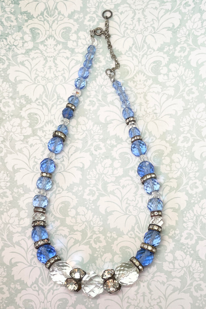 This beautiful necklace is made with crystal beads in a lovely clear blue colour, and three large clear crystal faceted beads. There are old diamante spacers