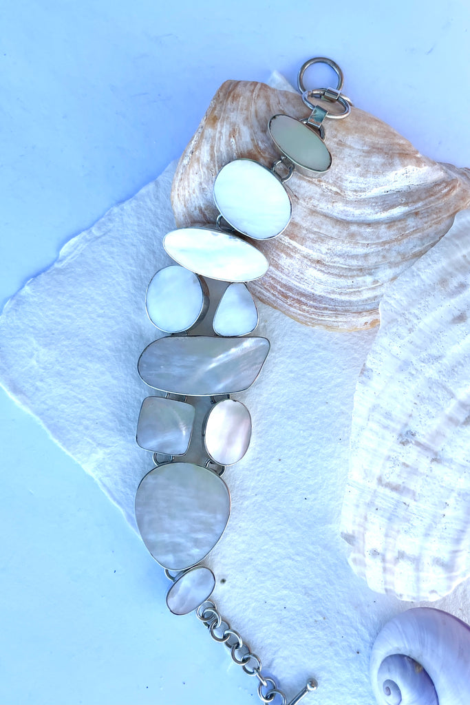 A lovely shimmery creamy white mother of pearl bracelet, each linked  shape has been individually cut and rim set into 925 silver.  