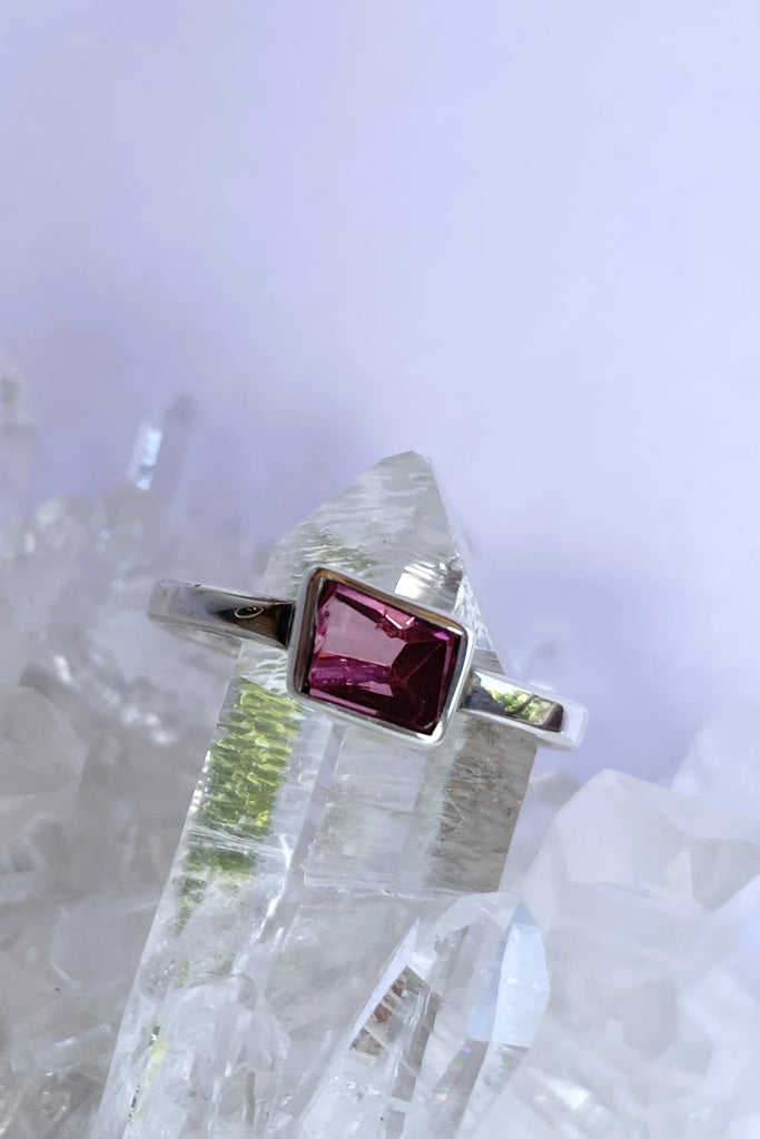 This natural pink tourmaline has been cut in an elegant free form geometric style, then set to fit its unique lines and brilliant colours creating a one of a kind piece. 
