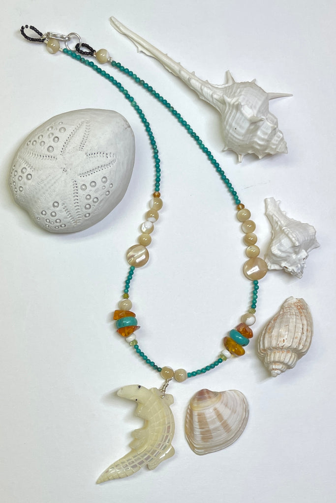 This necklace is a one off piece, the stones are all natural semi precious gems and mother of pearl shell. The crocodile is hand carved from a mother of pearl sea shell