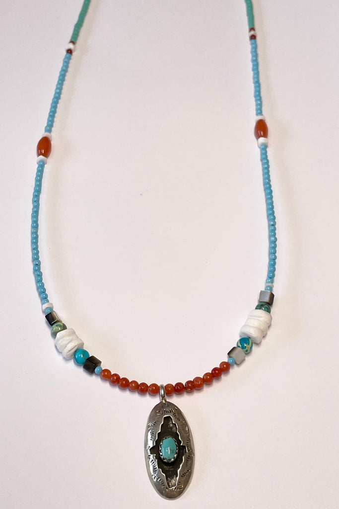 lovely choker style necklace has a sterling silver centre piece with a natural turquoise cabochon in the centre, it is stamped Moondance.