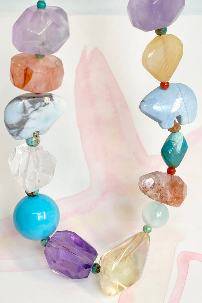 The necklace features two hand carved Zuni bears bought in Tucson Arizona. Stones are Natural Turquoise, Pearl, Amethyst, Carnelian, Clear Rock Crystal Blue Lace Agate,. Citrine, Mother of Pearl shell, Strawberry Quartz and Peridot. 