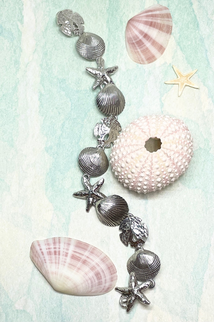 925 solid silver seashells starfish and sand dollars all connected around the wrist to create this unique and beautiful bracelet.