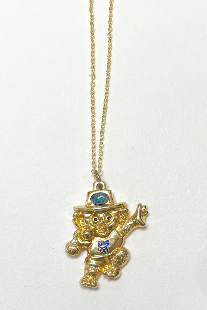 A very quirky pendant, a Koala with a shot putt, there is a conceptual opal on the head. The opal is made from genuine opal chips held in resin. On the back inscribed with Aust. Olympic C'tee. Australian Olympic Souvenir.