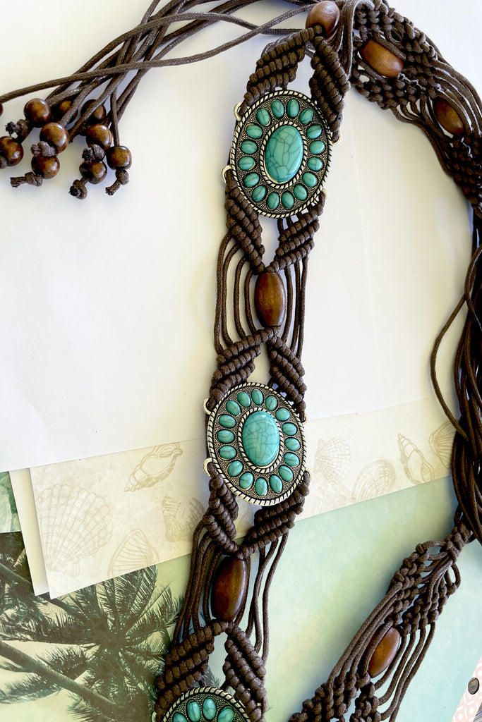 a macrame knotted and beaded belt embellished with turquoise beaded conch detail. 
