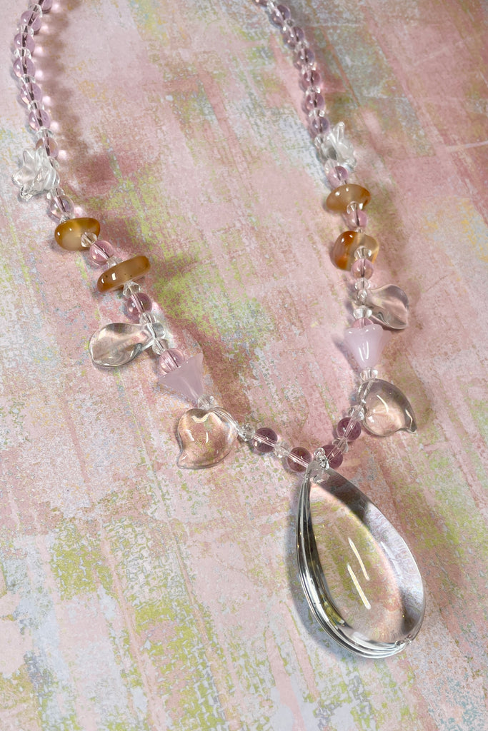 crystal glass necklace, the centre piece is a chandelier style crystal glass drop, with pale carnelian and pink glass beads. 