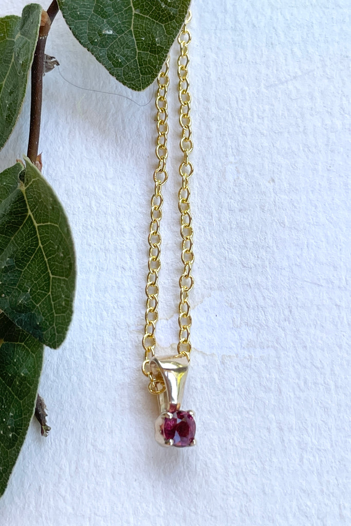 This adorable Luna pendant is made in 9ct gold, the stone is a lovely dark pink 3mm Tourmaline gemstone. A tiny delicate and sophisticated gemstone pendant.