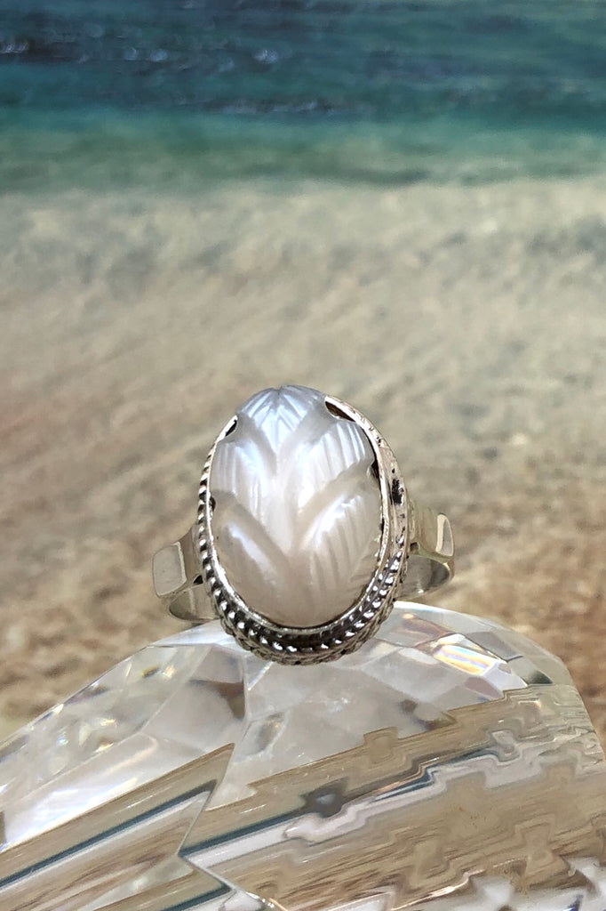 The Echo Ring Moonstone Carving is a handmade moonstone cabachon ring  featuring set in silver with a hand carved leaf design. 
