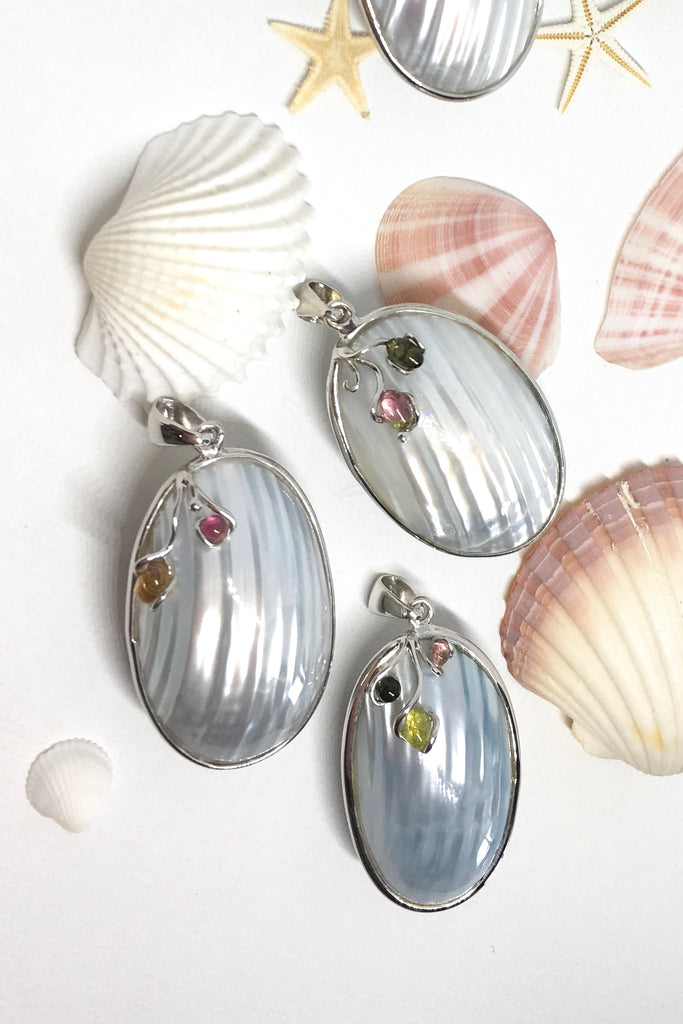 A sweet gentle shell pendant, in pale silvery blue