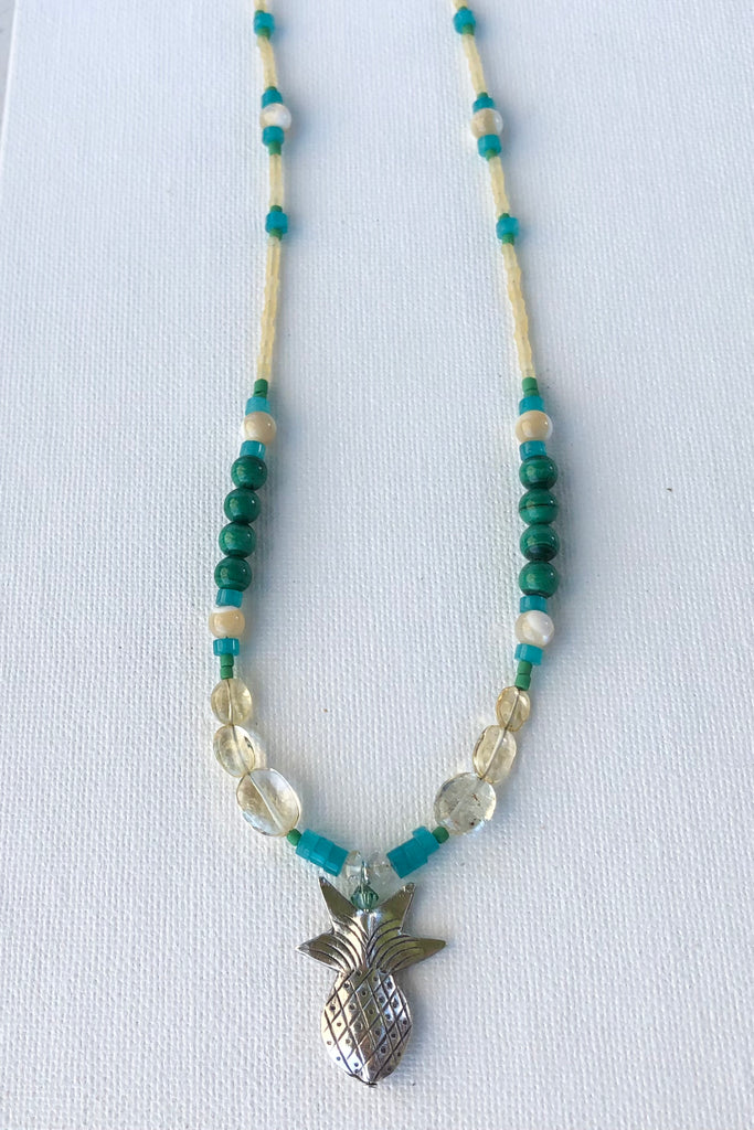 This necklace Sunny Coast inspired one off piece was made in our Noosa Studio,  There is a Thai silver pineapple as the central focus, the beads are the green, gold and turquoise of the area.