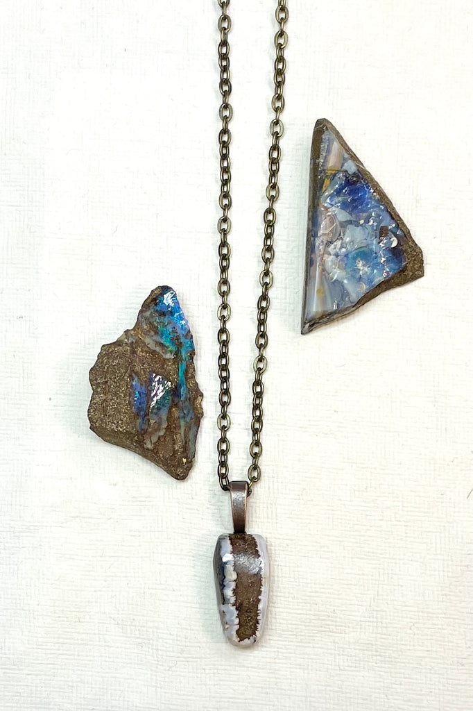  The pendant has a band of rock running down the centre and the edges have a crystalline opal edge.