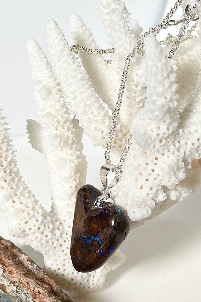 This intriguing and unique piece of opal was cut and polished into the heart shape for Mombasa Rose in Noosa, Queensland. The flashes of turquoise and teal go across and deep into the stone, giving it a flashing twinkling look. 