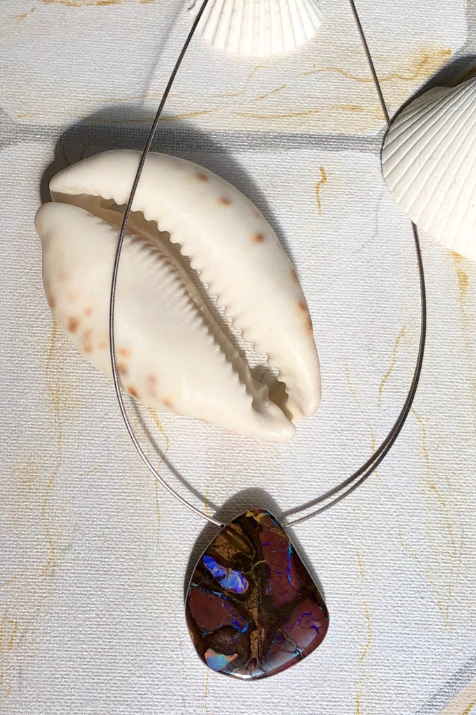  this intriguing piece of Boulder Opal was mined, cut and polished in Queensland. The flashes of colour give one a glimpse into the past. 