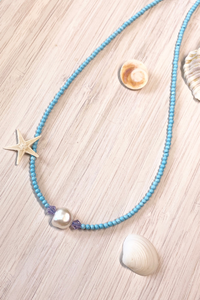  A delicate choker style necklace made with tiny sand seed beads, with a pearl and Swarovski crystal centre piece.