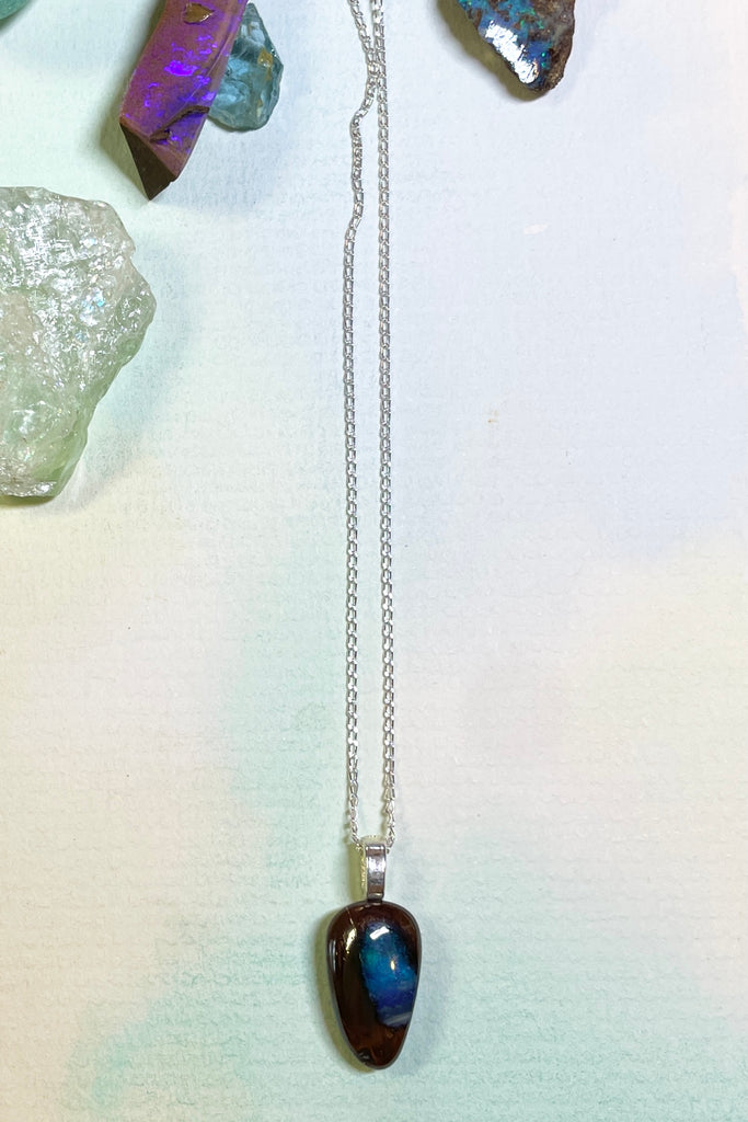 This tiny opal pendant has a gorgeous pond of deep blue flash in the centre.