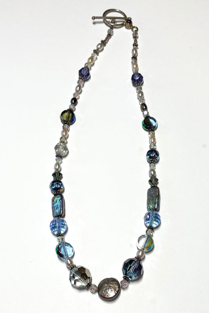 This beautiful necklace is made with vintage crystal beads in a lovely clear blue colour, and also new crystal beads. It also has grey pearls and palest pink pearls. 