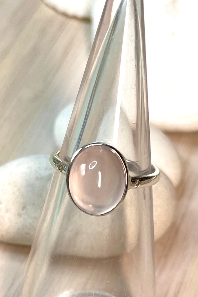 A beautiful feminine, pale luminous pink Rose Quartz  gemstone ring, this darling and dainty little ring has a tiny genuine diamond set into the band on each side of the centre stone.