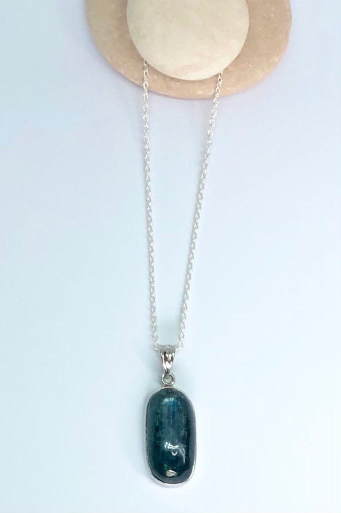  this stone is a greenish grey blue with silvery flashes. It is clear sea green when held to the light, cut to a lovely high dome oval cabochon.
