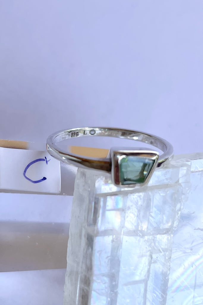 This pale blue green natural tourmaline has been cut in an elegant free form geometric style, then set to fit its unique lines and brilliant colours creating a one of a kind piece. 