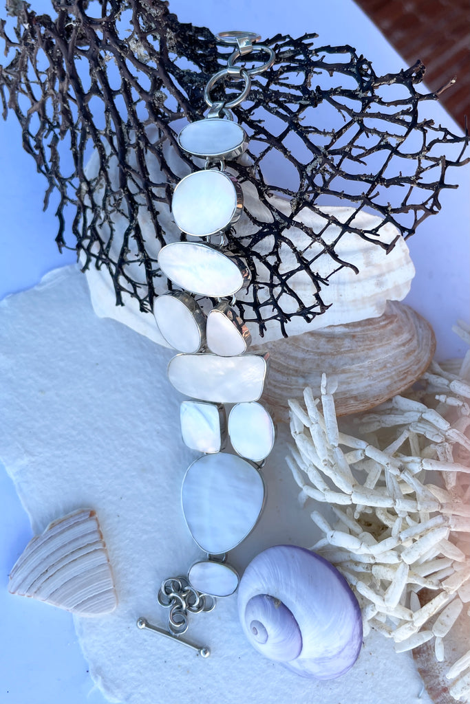 A lovely shimmery creamy white mother of pearl bracelet, each linked  shape has been individually cut and rim set into 925 silver.  