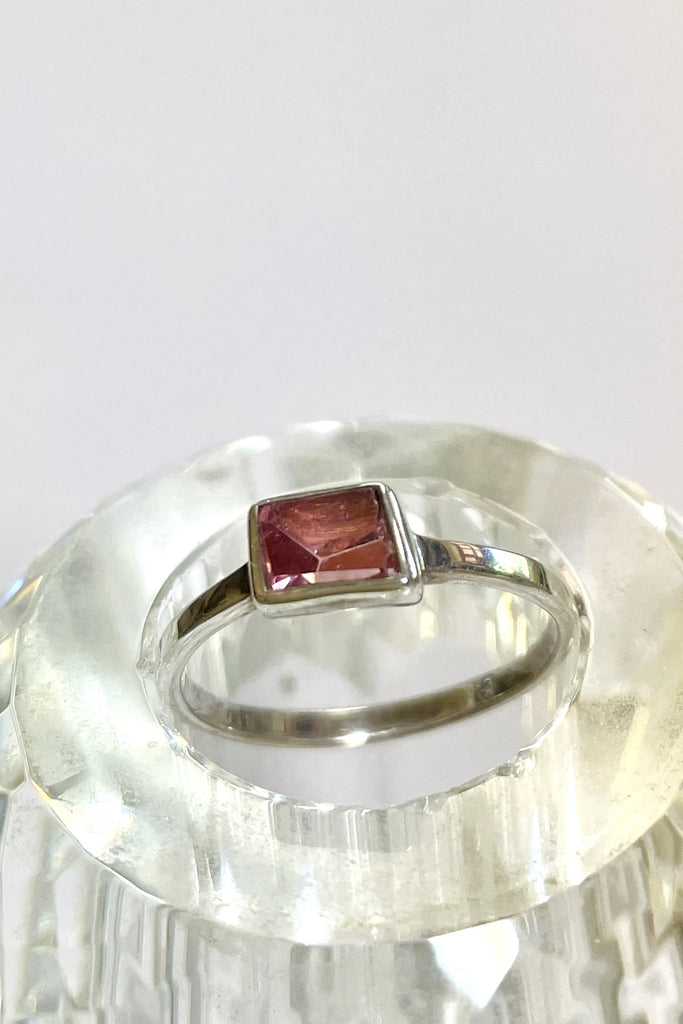 This natural pink tourmaline has been cut in an elegant free form geometric style, then set to fit its unique lines and brilliant colours creating a one of a kind piece. 