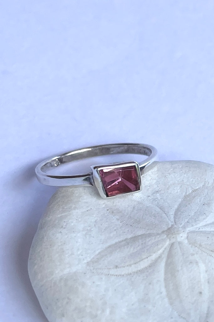 This natural pink tourmaline has been cut in an elegant free form geometric style, then set to fit its unique lines and brilliant colours creating a one of a kind piece. 