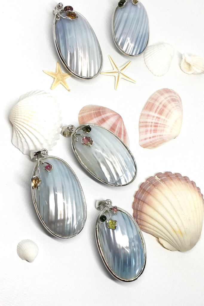 A sweet gentle shell pendant, in pale silvery blue