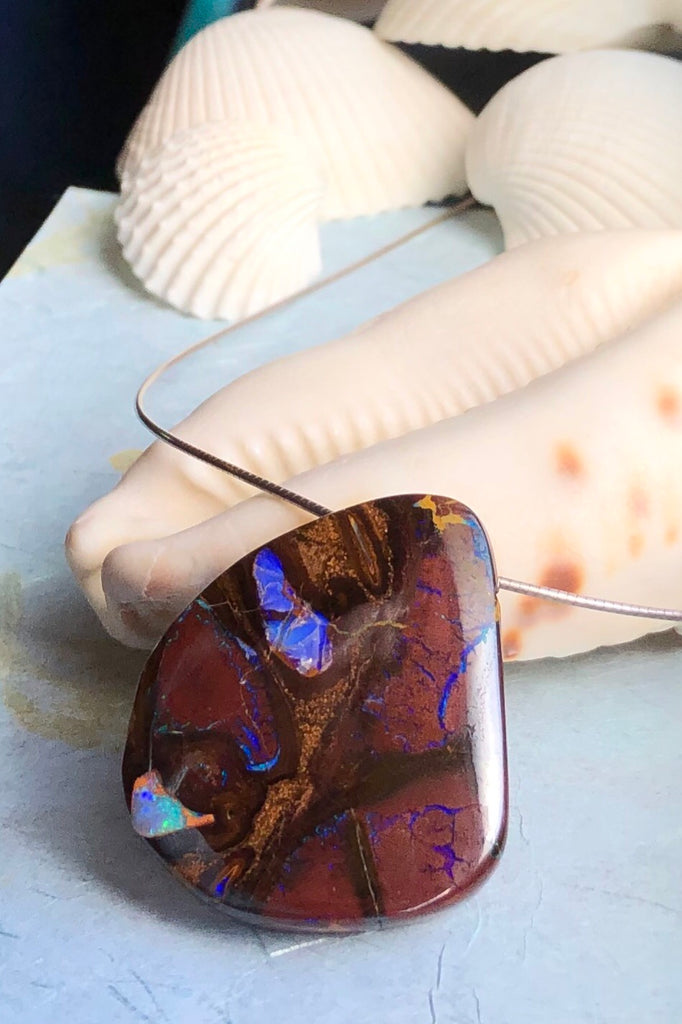  this intriguing piece of Boulder Opal was mined, cut and polished in Queensland. The flashes of colour give one a glimpse into the past. 