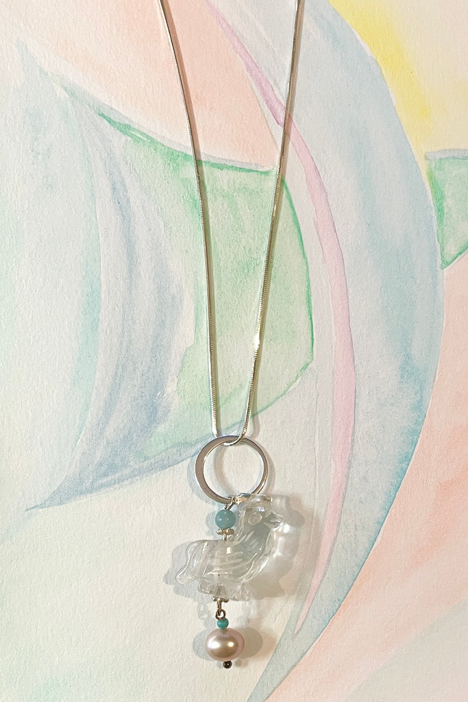 A little hand carved rock crystal rooster on a silver chain. With Amazonite and turquoise beads, a lovely pink pearl hangs at the base, this makes pendant perfection. 