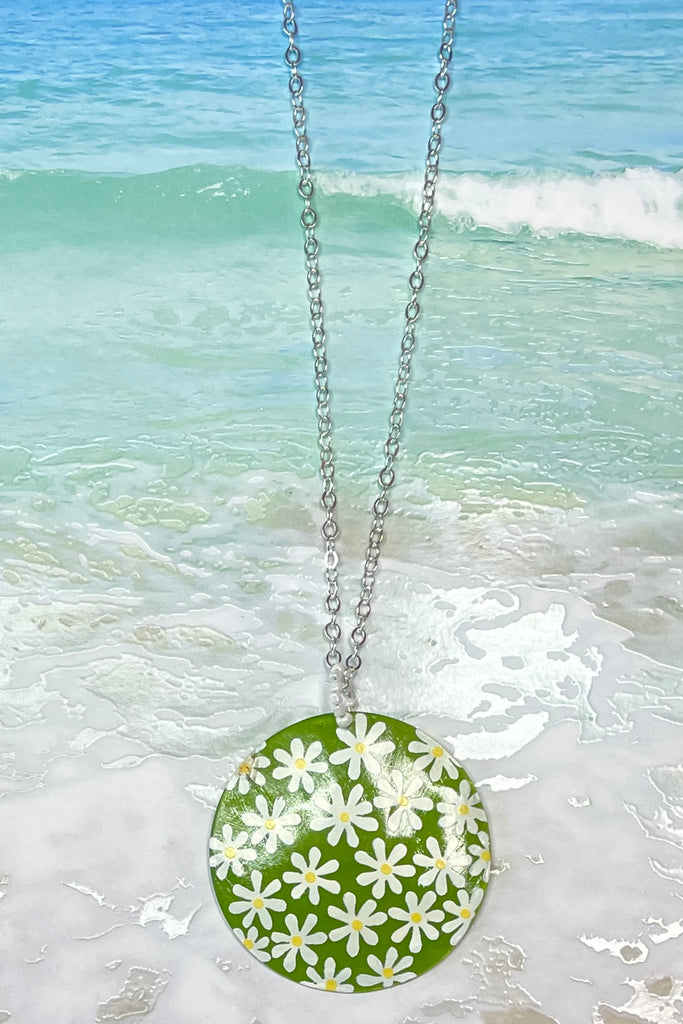 sweetheart daisy necklace is a Capiz shell circle hand painted with 60's style daisies