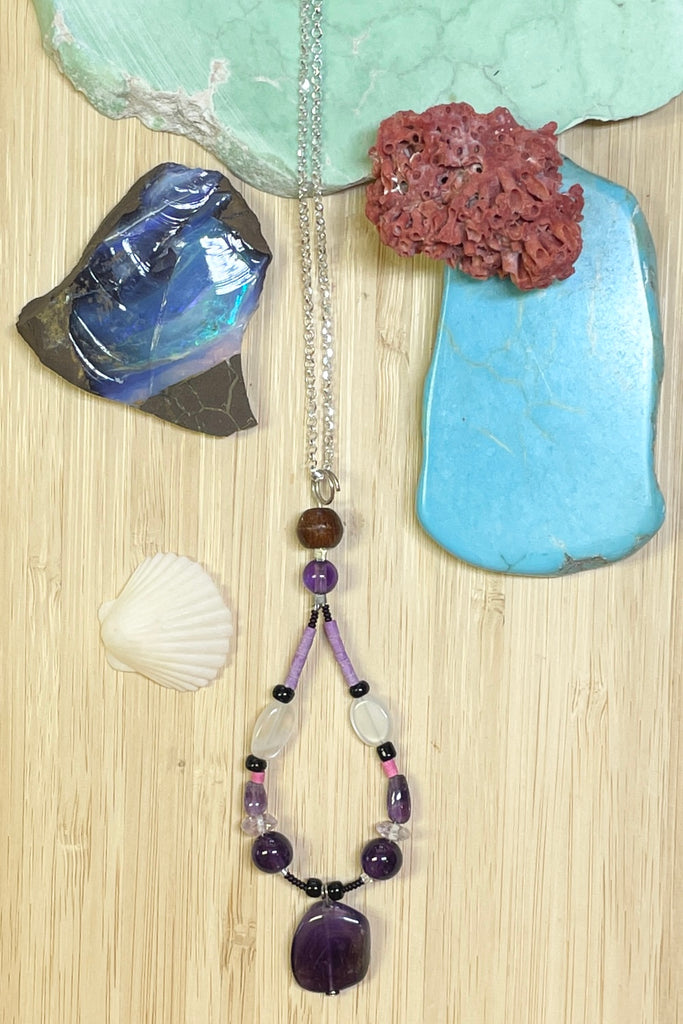 Handmade talisman pendant, featuring a mix of natural material