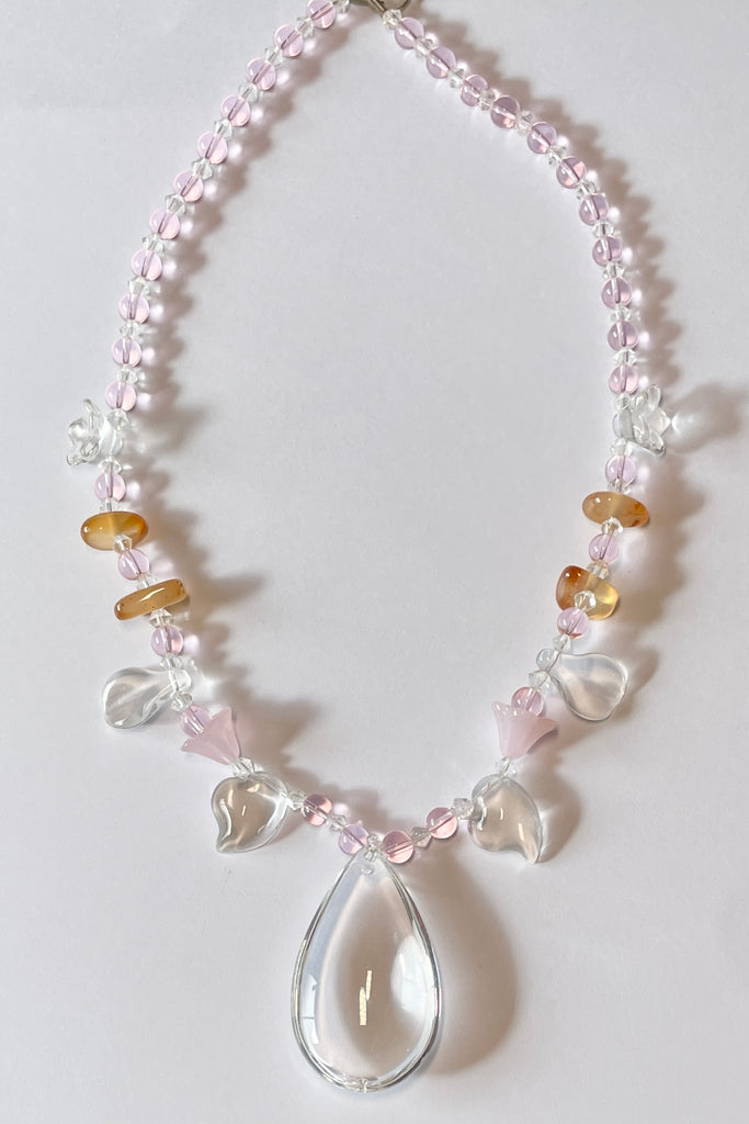 crystal glass necklace, the centre piece is a chandelier style crystal glass drop, with pale carnelian and pink glass beads. 