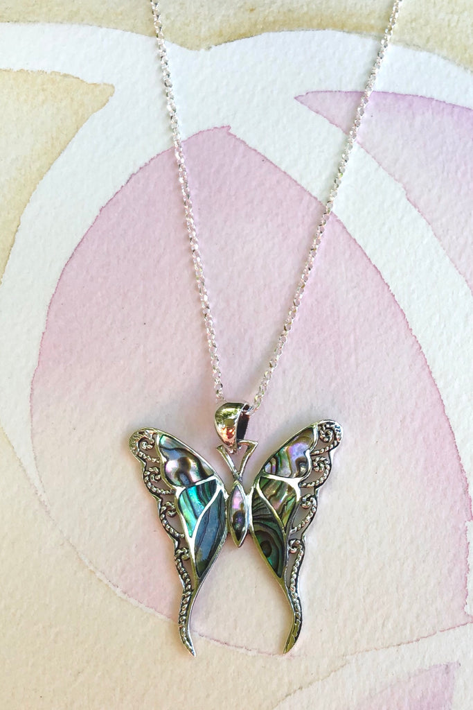 A gorgeous retro style butterfly necklace in shiny silver, with inlaid exotic rainbow Paua shell.