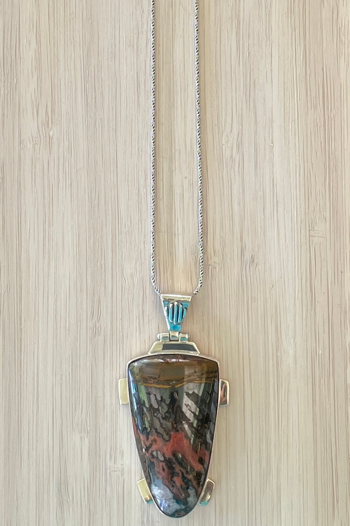 A powerful and intriguing Morrocan Jasper pendant reflecting the story of the ancient rock. A modernist setting in a unique design,