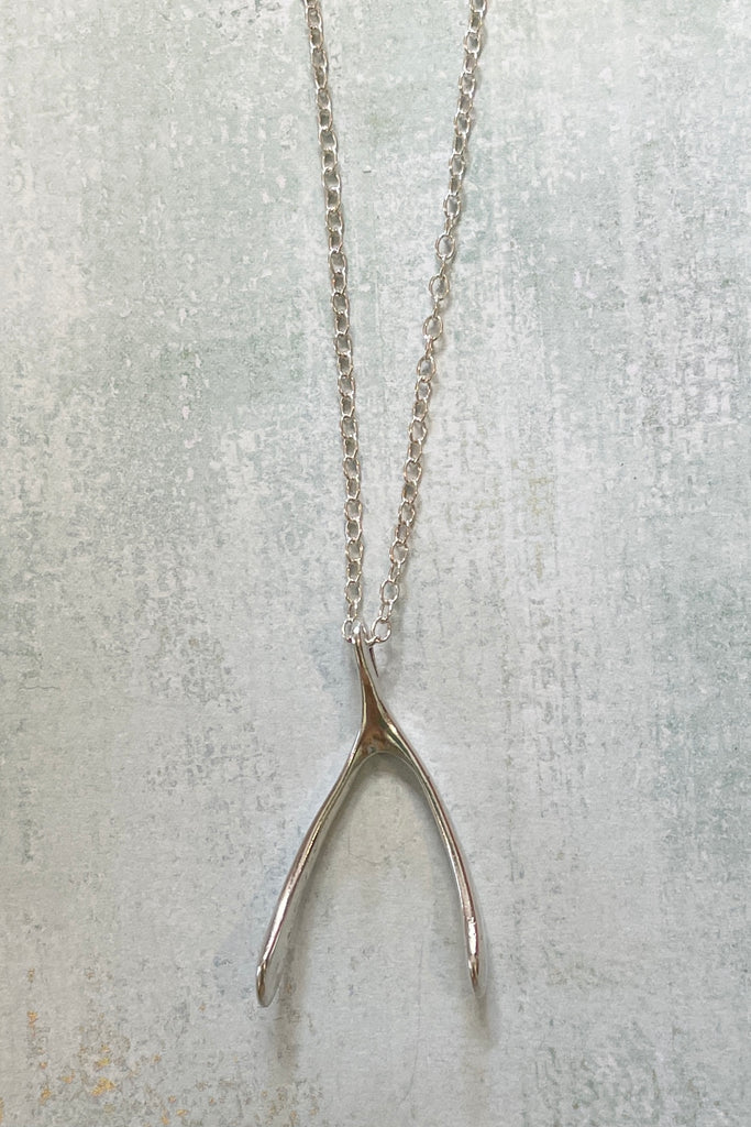 A small silver wishbone pendant, this is a vintage piece 