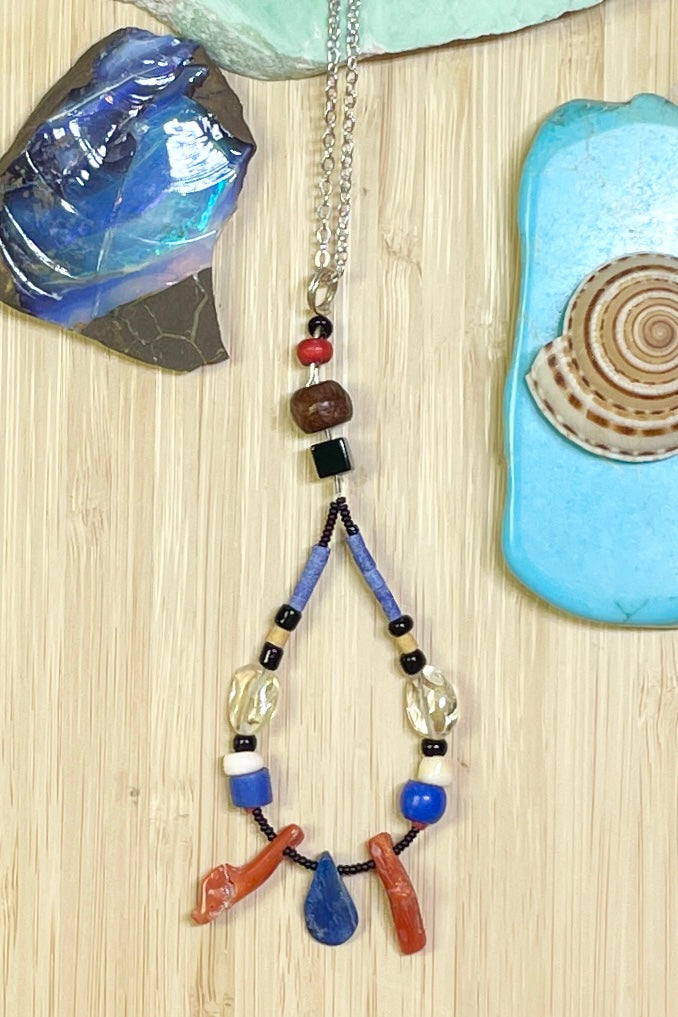 Handmade talisman pendant, featuring a mix of natural material