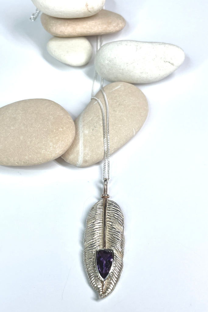 silver feather pendant was designed exclusively for Mombasa Rose, it has a sparkling natural Amethyst set into the piece, it hangs from a good 925 silver chain. 