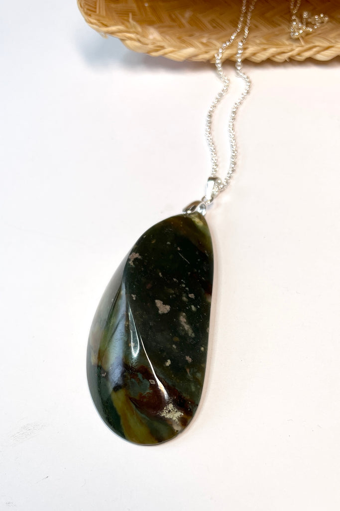 This pendant is a lovely piece of deep grey green Agate stone that has been skillfully cut into a pleasing swirl shape then polished, by ROAM Ladies Lapidary Collective in Sakaraha, Madagascar.