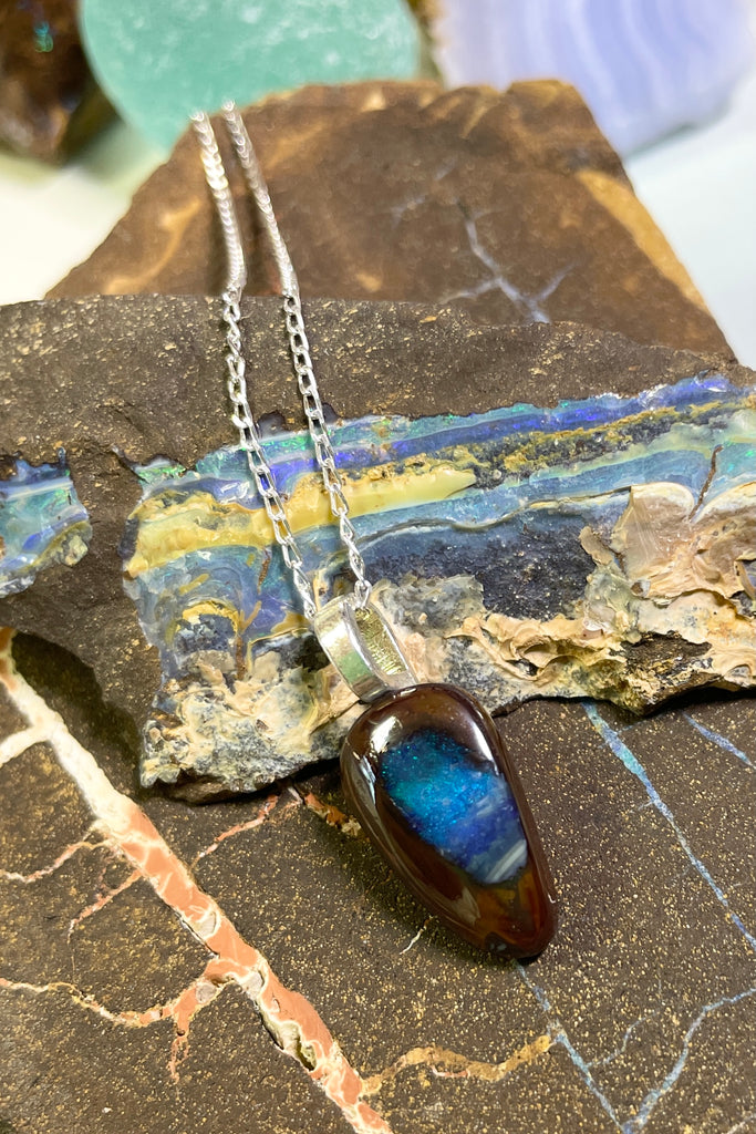 This tiny opal pendant has a gorgeous pond of deep blue flash in the centre.