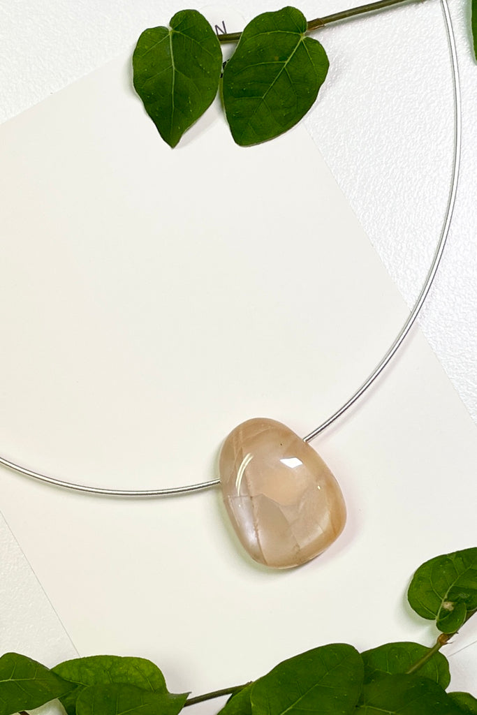 The Pendant is a really lovely luminescent peach moonstone, it hangs from a 925 silver Omega chain. 