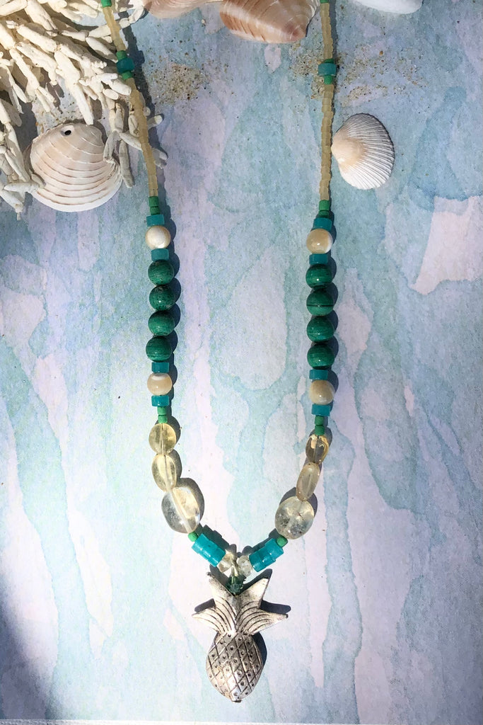 This necklace Sunny Coast inspired one off piece was made in our Noosa Studio,  There is a Thai silver pineapple as the central focus, the beads are the green, gold and turquoise of the area.