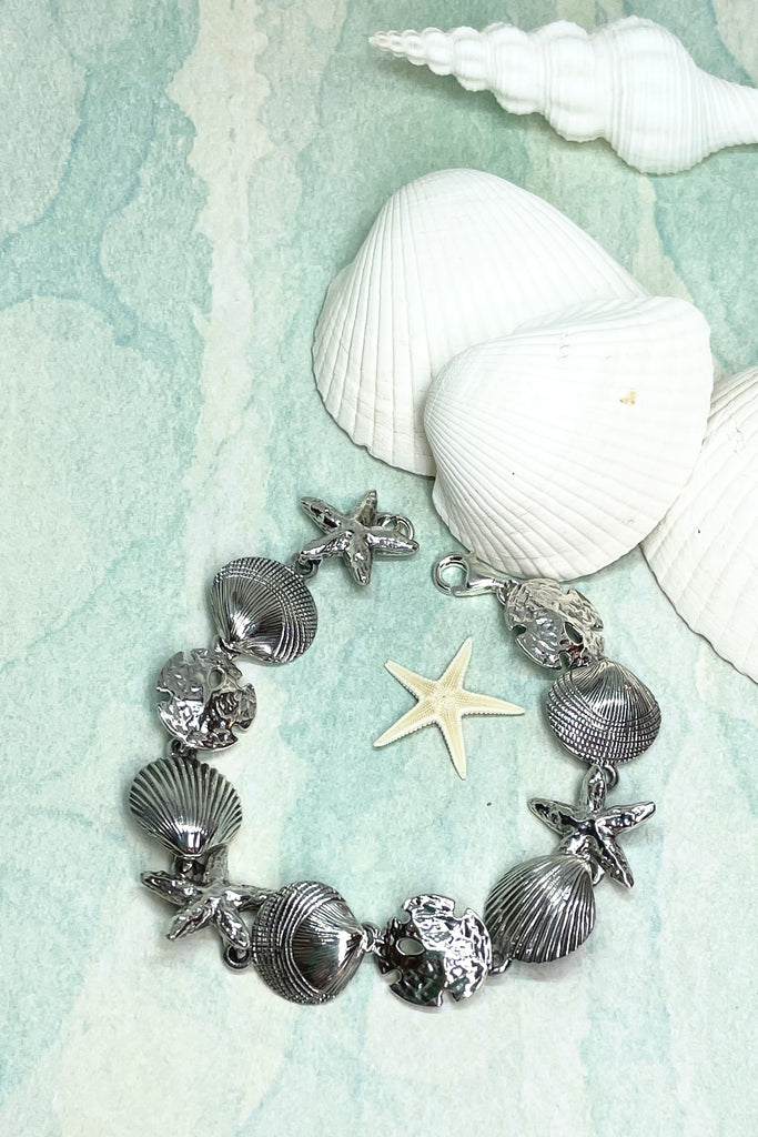 925 solid silver seashells starfish and sand dollars all connected around the wrist to create this unique and beautiful bracelet.
