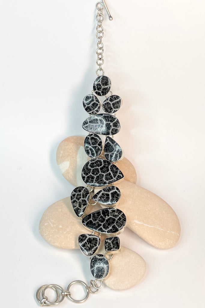 lovely Smokey silver grey mother of pearl bracelet, each shape has been individually set and rim set into heavy 925 silver. A very pretty and well made bracelet.